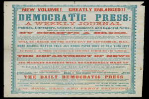 Zeitung mit dem Text "Demokratische Presse: Eine Wochenzeitung" auf schwarzem Hintergrund.