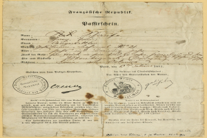 Alter deutscher Regierungsbrief mit rundem, schwarz umrandetem Stempel auf gelbem Papier, geschrieben in schwarzer Tinte.